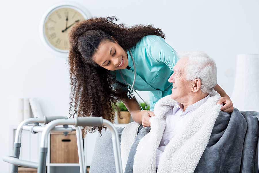 Elderly gentleman cared for by nurse in his home